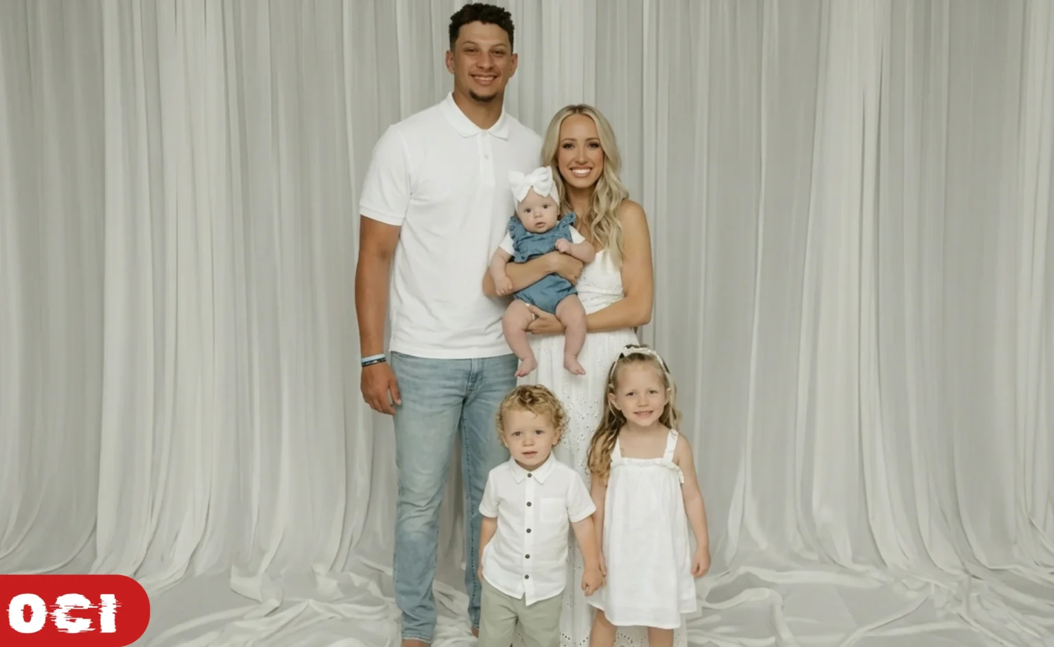 Patrick and Brittany Mahomes pictured with their three children at a public event